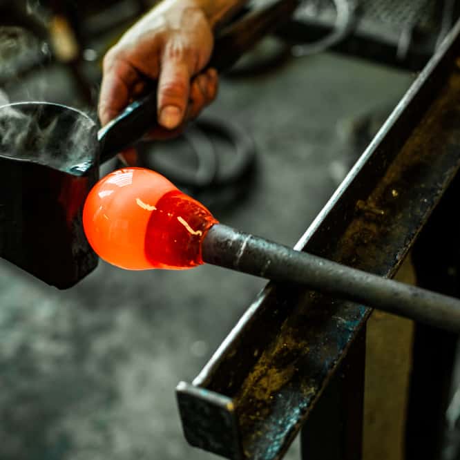 Liquid glass is blown into the mold